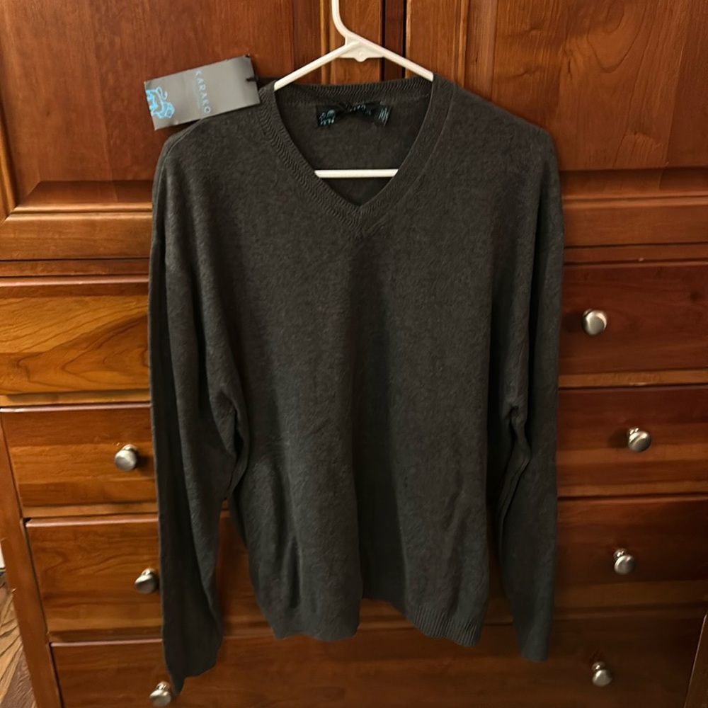 NWT grey v-neck sweater. Loosely ribbed bottom